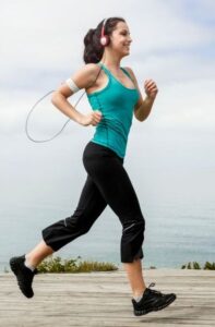Woman running wearing headphones